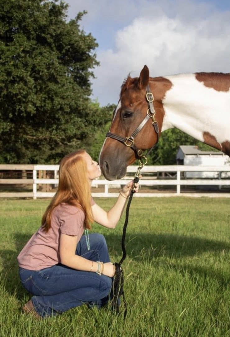 Young girl hugging horse at Circle Lake Ranch summer horse camp in Katy Texas
